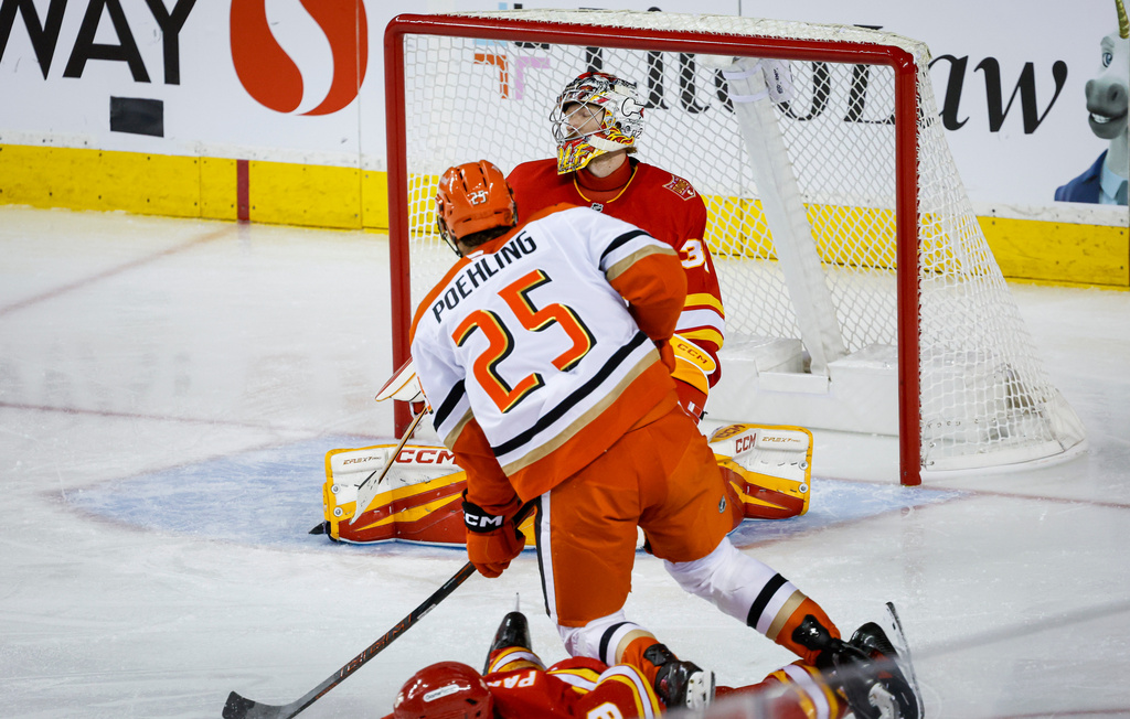 Anaheim Ducks' Ryan Poehling scores on Calgary Flames goalie Dustin Wolf during the third period of an NHL hockey game in Calgary, Alberta, Alberta, Saturday, Oct. 10, 2026. (Jeff McIntosh/The Canadian Press via AP)