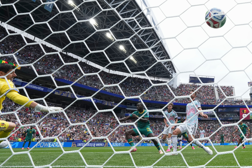 Senegal's Habib Diarra (21) scores their first goal past Belgium goalkeeper Thibaut Courtois, left, and Belgium's Brandon Mechele, right, during the World Cup round of 32 soccer match between Belgium and Senegal in Seattle, Wednesday, July 1, 2026. (AP Photo/Abbie Parr)