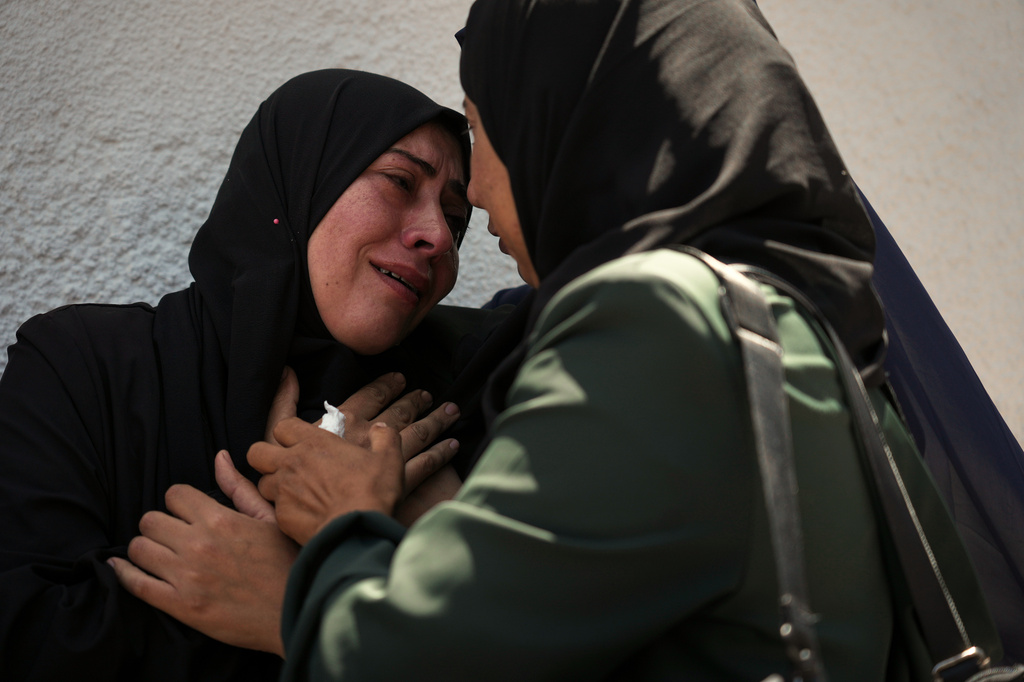 Palestinians attend the funeral of their relatives who were killed in an Israeli strike, in Gaza City, Thursday, June 4, 2026. (AP Photo/Jehad Alshrafi)