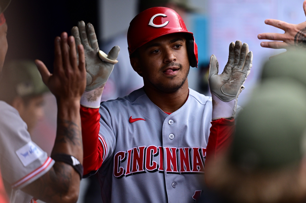 Cincinnati Reds' Dane Myers is congratulated in the dugout after hitting a solo home run off Cleveland Guardians starting pitcher Joey Cantillo during the third inning of a baseball game, Saturday, May 16, 2026, in Cleveland. (AP Photo/David Dermer)