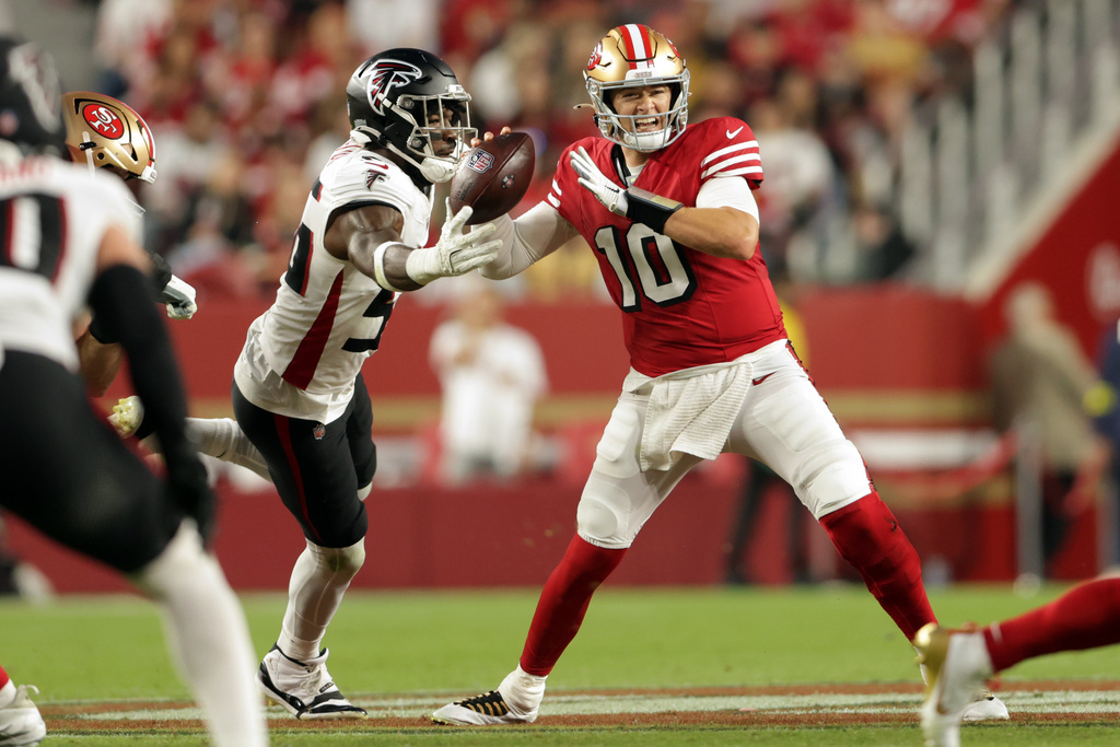 San Francisco 49ers' Mac Jones, right, is pressured by Atlanta Falcons' Leonard Floyd in second quarter of an NFL football game in Santa Clara, Calif., on Sunday, Oct. 19, 2025. (Scott Strazzantez/San Francisco Chronicle via AP)