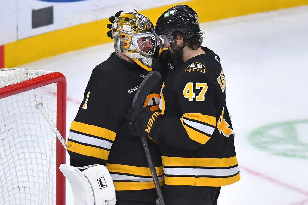 Boston Bruins goaltender Jeremy Swayman (1) celebrates with center Mark Kastelic (47) after the Bruins beat the New Jersey Devils in an NHL hockey game, Saturday, Dec. 6, 2025, in Boston. (AP Photo/Steven Senne)