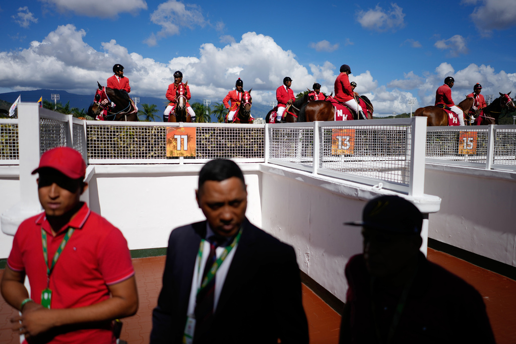 Judges wait between races during the 56th Jockey Challenge at the Rinconada racetrack in Caracas, Venezuela, Sunday, Dec. 14, 2025. (AP Photo/Ariana Cubillos)