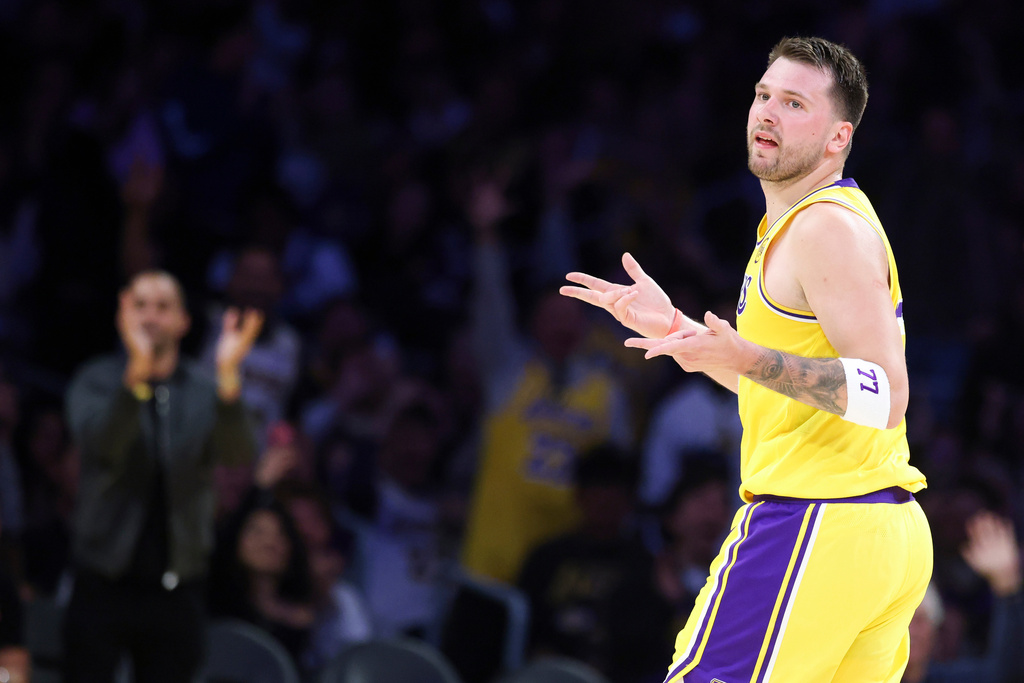 Los Angeles Lakers guard Luka Doncic gestures after scoring a 3-point basket against the Los Angeles Clippers during the first half of an NBA basketball game, Friday, Feb. 20, 2026, in Los Angeles. (AP Photo/Jessie Alcheh)