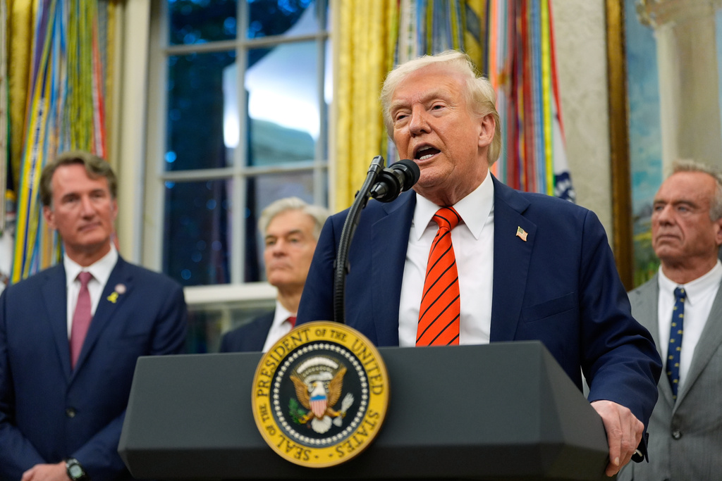 President Donald Trump speaks in the Oval Office of the White House, Friday, Oct. 10, 2025, in Washington, as Virginia Gov. Glenn Youngkin, Centers for Medicare & Medicaid Services administrator Dr. Mehmet Oz and Health and Human Services Secretary Robert F. Kennedy Jr., listen. (AP Photo/Alex Brandon)