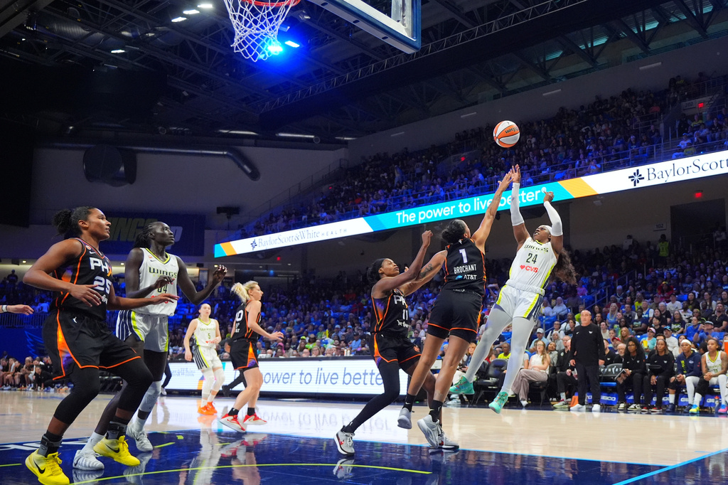 Dallas Wings guard Arike Ogunbowale (24) shoots against Phoenix Mercury forwards Noemie Brochant (1) and Valeriane Ayayi (11) during the first half of a WNBA basketball game in Arlington, Texas, Saturday, Sept. 19, 2026. (AP Photo/LM Otero)