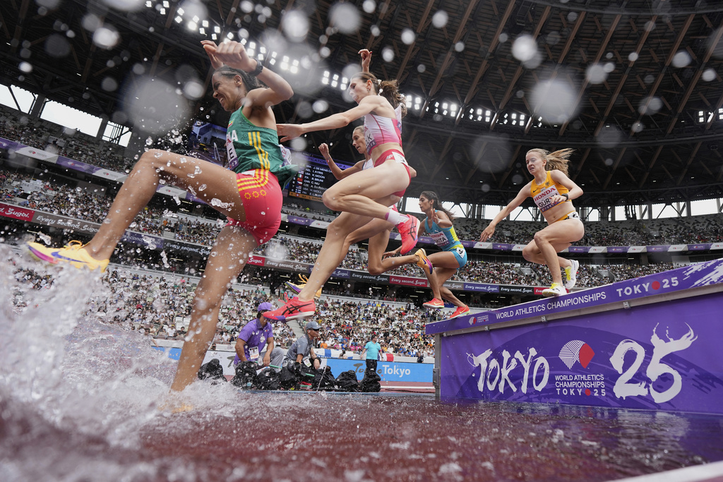 Runners compete in a heat of the women's 3,000 meters steeplechase at the World Athletics Championships in Tokyo, Monday, Sept. 15, 2025. (AP Photo/Ashley Landis)