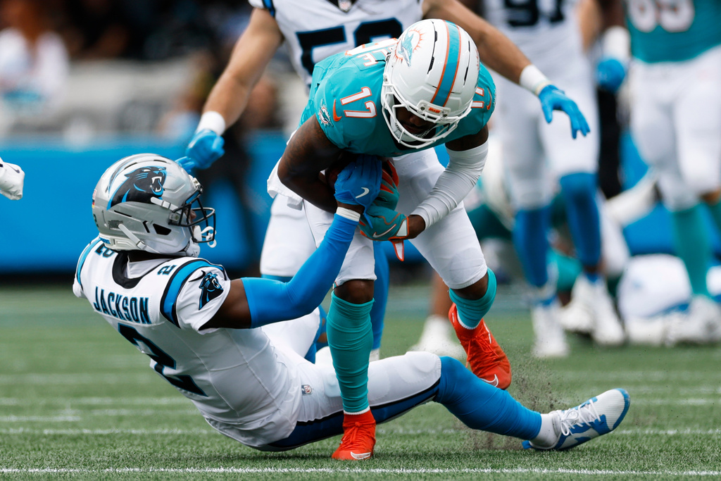 Miami Dolphins wide receiver Jaylen Waddle is tackled by Carolina Panthers cornerback Mike Jackson during the second half of an NFL football game, Sunday, Oct. 5, 2025, in Charlotte, N.C. (AP Photo/Rusty Jones)