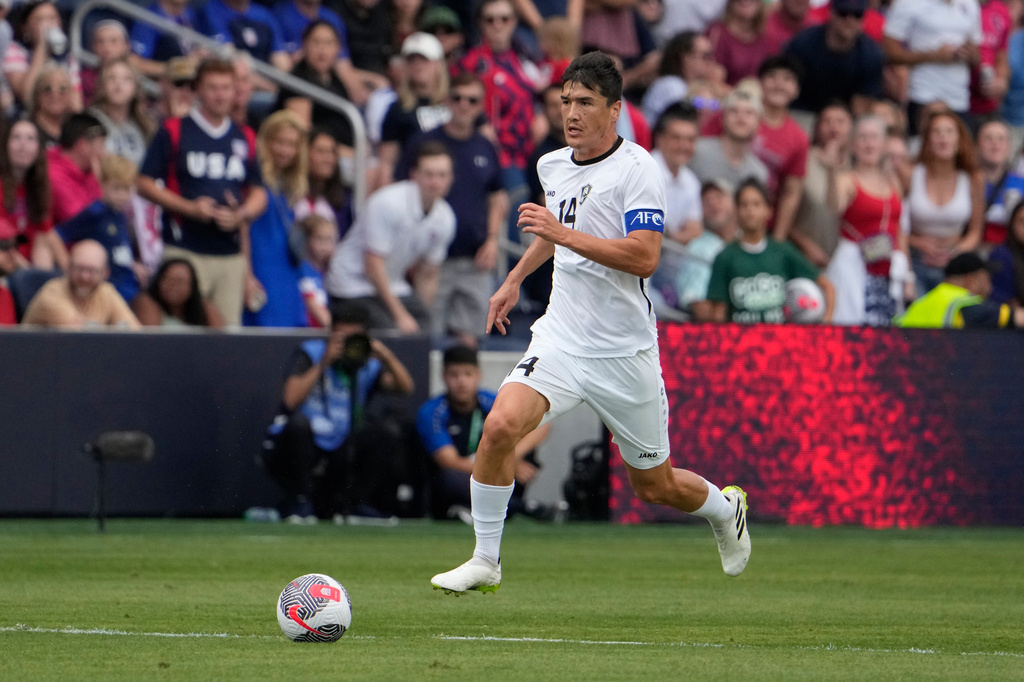 FILE - Uzbekistan's Eldor Shomurodov (14) brings the ball down the pitch during the first half of an international friendly soccer match against the United States Saturday, Sept. 9, 2023, in St. Louis. (AP Photo/Jeff Roberson, File)