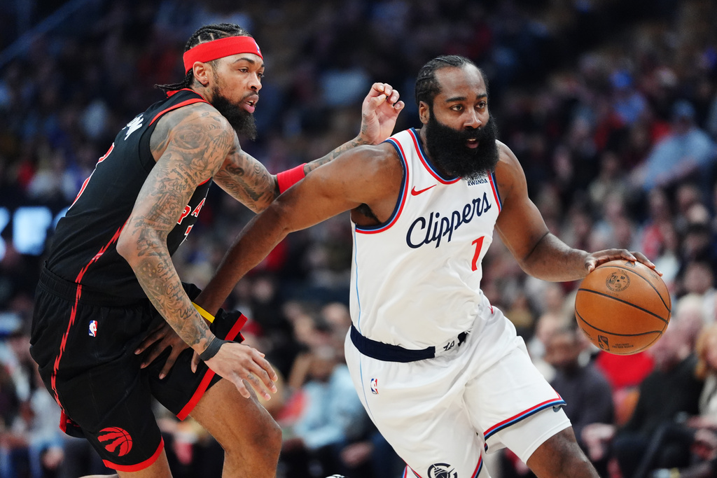 Los Angeles Clippers' James Harden (1) drives past Toronto Raptors' Brandon Ingram, left, during first-half NBA basketball game action in Toronto, Friday, Jan. 16, 2026. (Frank Gunn/The Canadian Press via AP)
