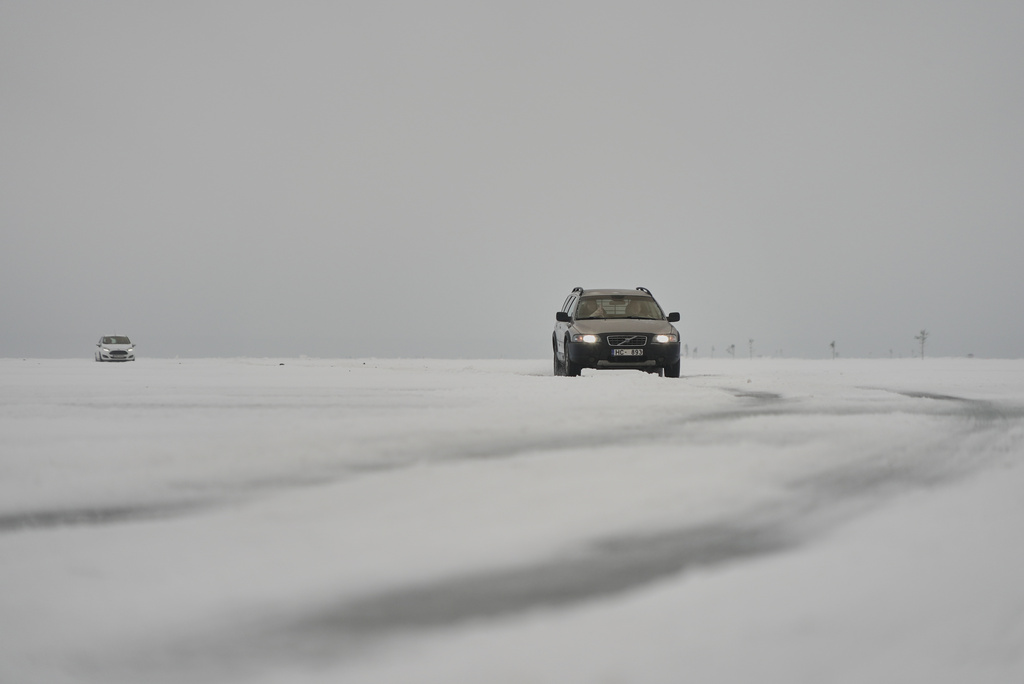 Two cars cross the frozen Soela Strait in the Baltic Sea near Hiiumaa, Estonia, Tuesday, Feb. 10, 2026. (AP Photo/Kostya Manekov)