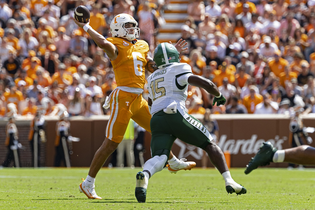 Tennessee quarterback Joey Aguilar (6) throws to a receiver as he's chased by UAB defensive end Jamichael Rogers (15) during the first half of an NCAA college football game Saturday, Sept. 20, 2025, in Knoxville, Tenn. (AP Photo/Wade Payne)