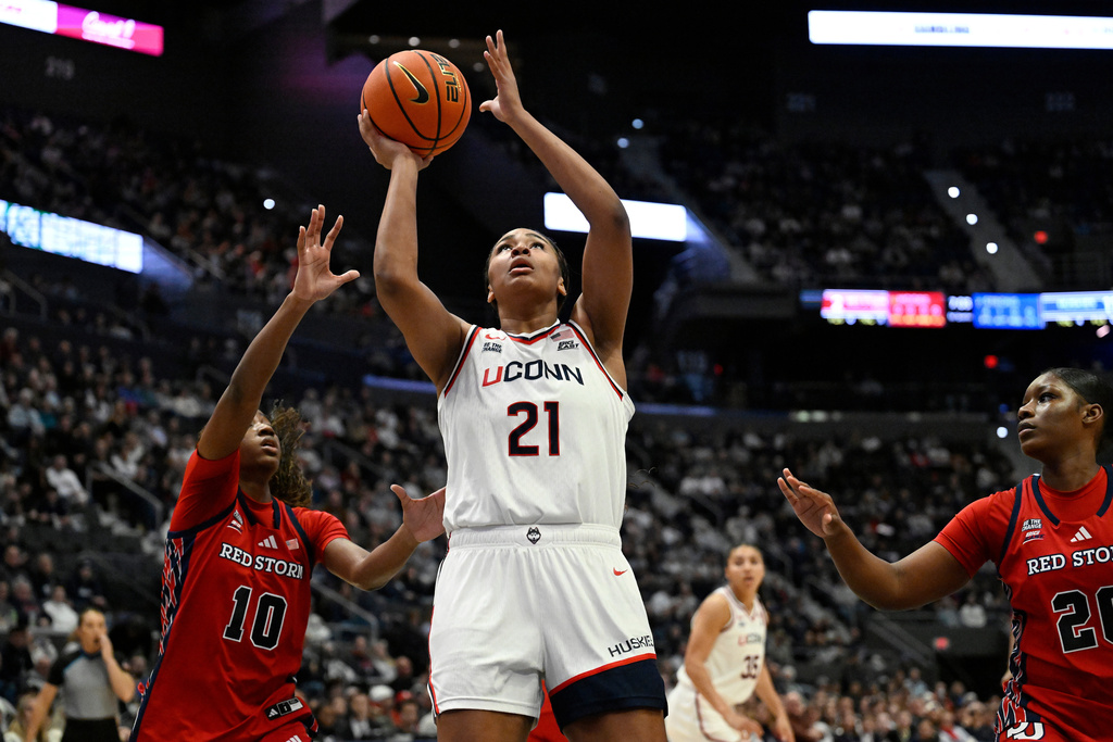 UConn forward Sarah Strong (21) shoots as St. John's guard Brooke Moore (10) defends in the first half of an NCAA college basketball game, Wednesday, Jan. 7, 2026, in Hartford, Conn. (AP Photo/Jessica Hill)