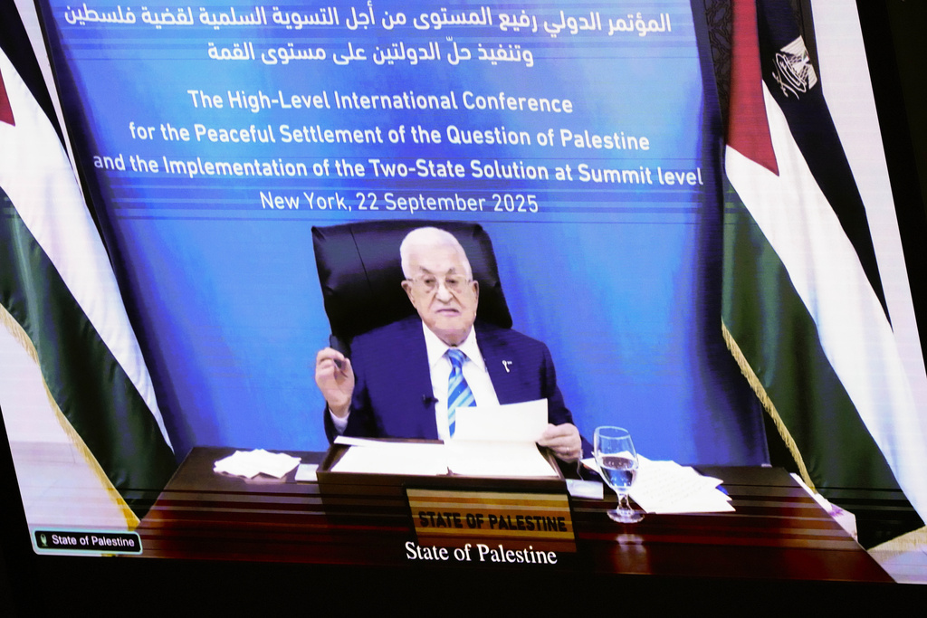 Palestinian President Mahmoud Abbas appears on a screen as he speaks virtually during a high-profile meeting at the United Nations aimed at galvanizing support for a two-state solution to the Israeli-Palestinian conflict Monday, Sept. 22, 2025, at UN headquarters (AP Photo/Yuki Iwamura)