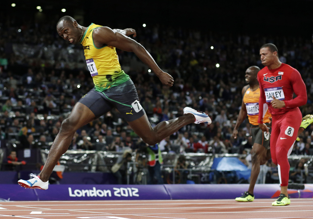 FILE - Jamaica's Usain Bolt crosses the finish line to win gold in the men's 100-meter final during the athletics in the Olympic Stadium at the 2012 Summer Olympics, London, Sunday, Aug. 5, 2012. (AP Photo/David J. Phillip, File)