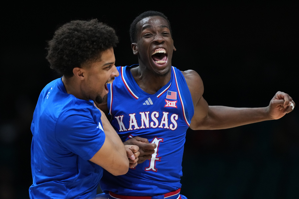 Kansas guard Melvin Council Jr., right, celebrates with teammate Justin Cross, left, after Kansas defeated Tennessee in an NCAA college basketball game in the Players Era tournament in Las Vegas, Wednesday, Nov. 26, 2025. (AP Photo/Eric Gay)