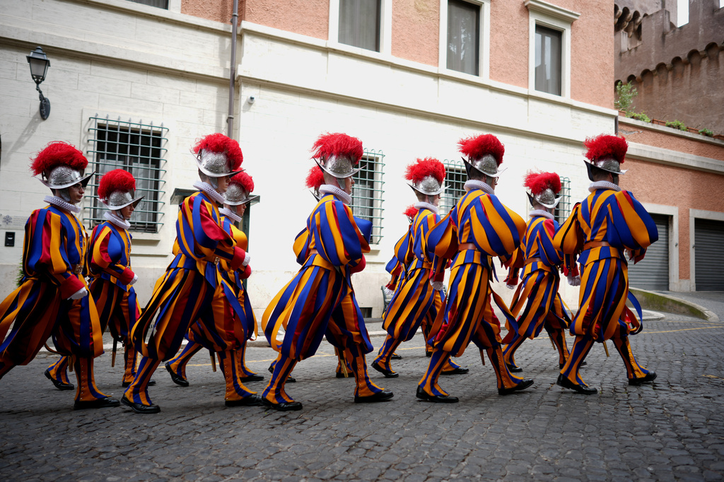Pontifical Swiss Guards march ahead of a swearing in ceremony, at the Vatican, Wednesday, May 6, 2026. (AP Photo/Andrew Medichini)