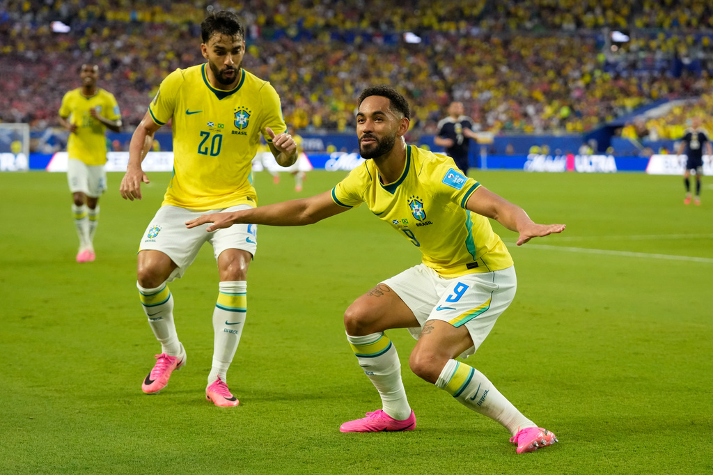 Brazil's Matheus Cunha (9) celebrates with Lucas Paqueta (20) after scoring their third goal during the World Cup Group C soccer match between Scotland and Brazil in Miami Gardens, Fla., Wednesday, June 24, 2026. (AP Photo/Lynne Sladky)