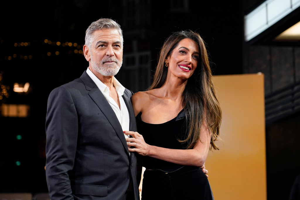 FILE - George Clooney and his wife Amal Clooney pose for photographers upon arrival at the screening of the film "The Boys In The Boat," Dec. 3, 2023, in London. (Photo by Alberto Pezzali/Invision/AP, File)