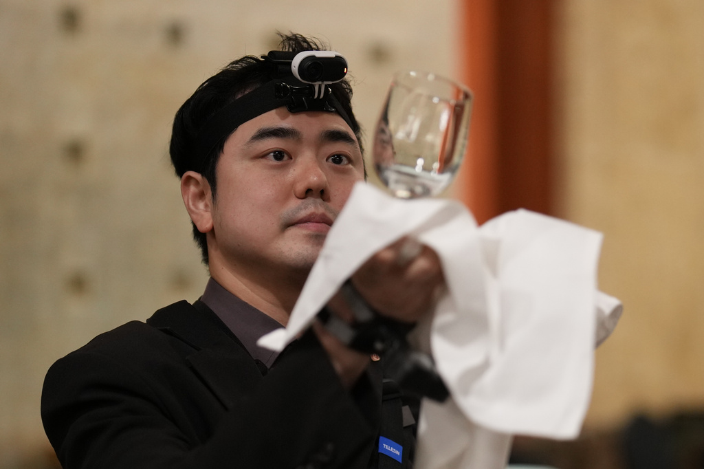 David Park, a food and beverages manager at Lotte Hotel Seoul, demonstrates during an interview with The Associated Press in Seoul, South Korea, Tuesday, April 28, 2026. (AP Photo/Lee Jin-man)