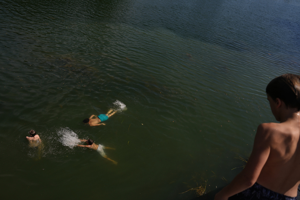 Young boys swim in the Seine river, in Samois-sur-Seine, south of Paris, Friday, June 19, 2026. (AP Photo/Thibault Camus)