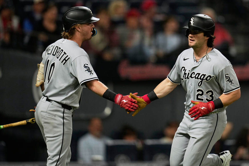 Chicago White Sox's Andrew Benintendi (23) is congratulated by Chase Meidroth, left, after scoring in the sixth inning of a baseball game against the Cleveland Guardians in Cleveland, Monday, Sept. 14, 2026. (AP Photo/Sue Ogrocki)