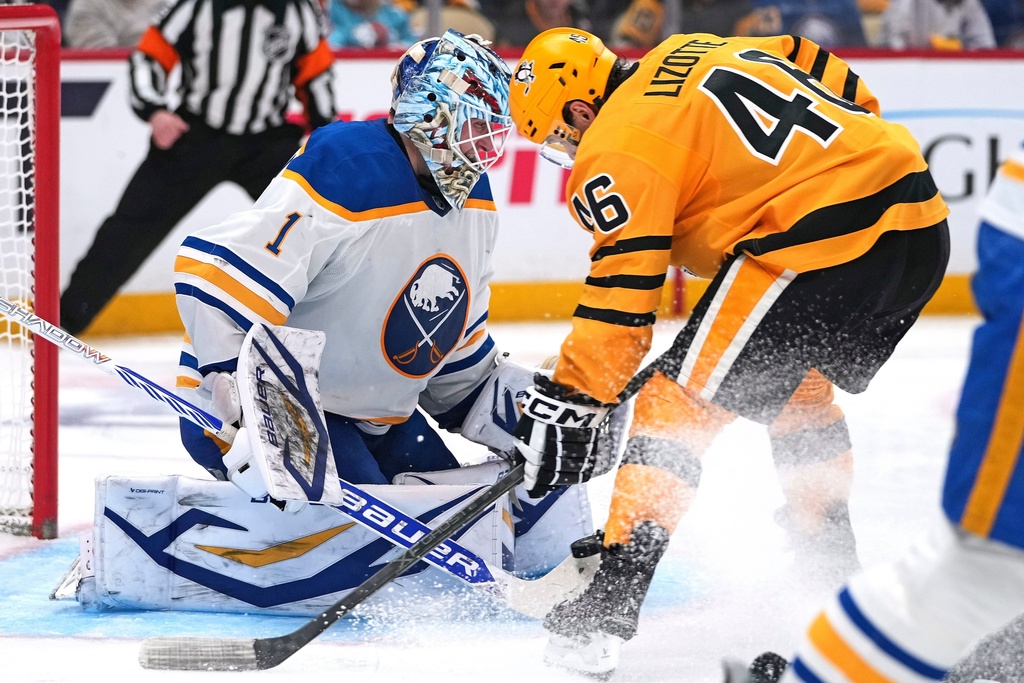 Buffalo Sabres goaltender Ukko-Pekka Luukkonen (1) blocks a shot by Pittsburgh Penguins' Blake Lizotte (46) during the second period of an NHL hockey game in Pittsburgh, Thursday, March 5, 2026. (AP Photo/Gene J. Puskar)