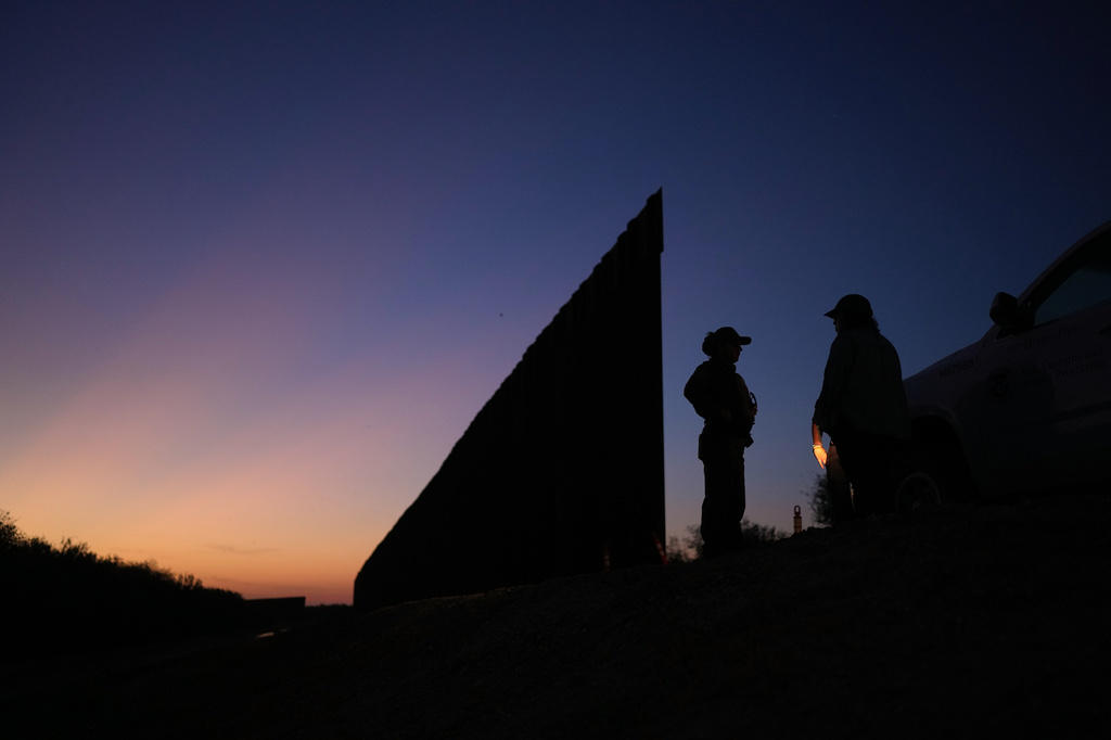 A U.S. Border Patrol agent stands near a new section of border wall at the Santa Ana Wildlife Refuge in Alamo, Texas, Tuesday, Aug. 25, 2026. (AP Photo/Eric Gay)