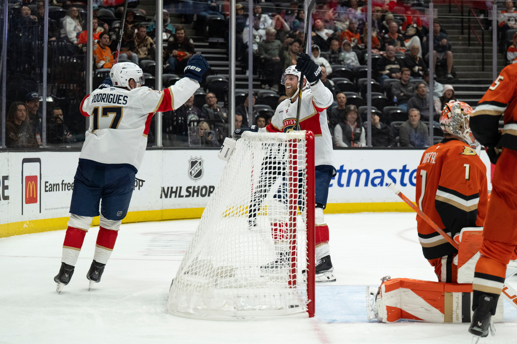Florida Panthers center Evan Rodrigues (17) and center Sam Bennett (9) celebrate a goal by Rodrigues during the second period of an NHL hockey game against the Anaheim Ducks, Tuesday, Nov. 4, 2025, in Anaheim, Calif. (AP Photo/Kyusung Gong)