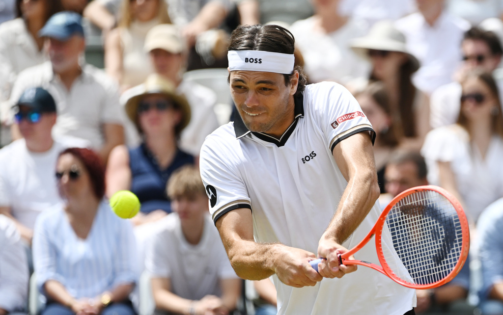 United States' Taylor Fritz returns the ball to United States' Ben Shelton during their Stuttgart Open tennis final match in Stuttgart, Germany, Sunday, June 14, 2026. (Marijan Murat/dpa via AP)