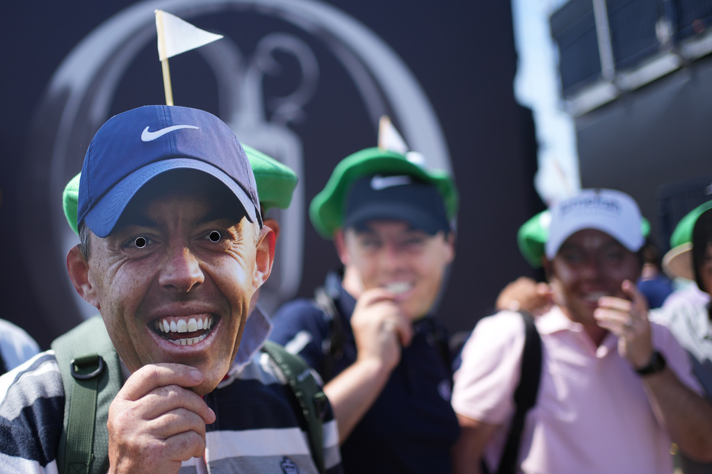 Golf fans with masks of Rory McIlroy, of Northern Ireland, pose near the 1st tee during the first day of the British Open Golf championships at Royal Birkdale golf club, in Southport, England, Thursday, July 16, 2026. (AP Photo/Jon Super)