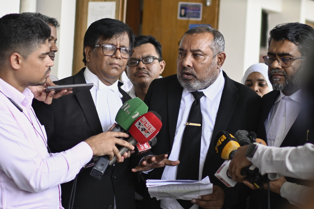 Public Prosecutor Muhammad Tariqul Islam, wearing a necktie, speaks to the media following a court hearing in the corruption case against former British Minister Tulip Siddiq at the Dhaka Special Judge Court-4, in Dhaka, Bangladesh, Wednesday, Aug. 13, 2025. (AP Photo/Mahmud Hossain Opu)