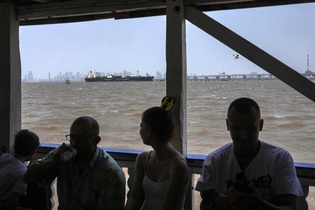 FILE - A tourist ferry sails past the Indian flagged LPG carrier Jag Vasant transporting liquefied petroleum gas, at the Mumbai Port in Mumbai, India, after it arrived clearing the Strait of Hormuz, April 1, 2026.(AP Photo/Rafiq Maqbool, File)