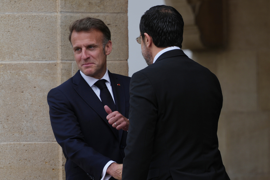 Cypriot President Nikos Christodoulides, right, and his French counterpart Emmanuel Macron shake hands at the presidential palace in Nicosia, Cyprus, Thursday, April 23, 2026. (AP Photo/Petros Karadjias)
