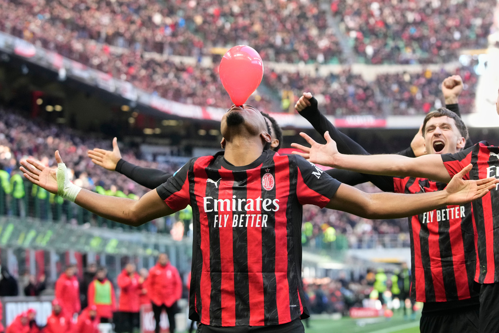 AC Milan's Christopher Nkunku celebrates after scoring his side's second goal from a penalty kick during a Serie A soccer match between AC Milan and Hellas Verona, in Milan, Italy, Sunday, Dec. 28, 2025. (AP Photo/Luca Bruno)