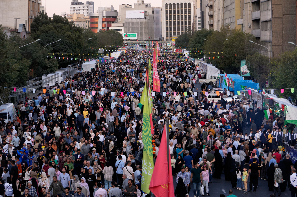 Crowds fill a street during celebrations marking Prophet Muhammad's birthday in Tehran, Iran, Sunday, Aug. 30, 2026. (AP Photo/Vahid Salemi)