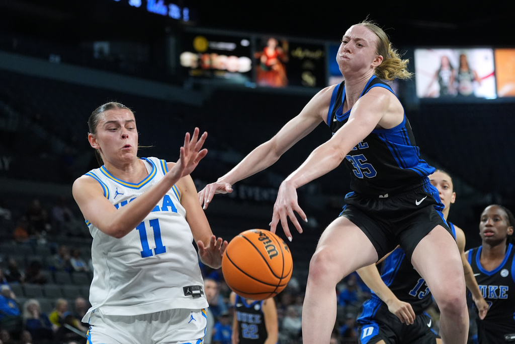 Duke forward Toby Fournier (35) knocks the ball away from UCLA forward Gabriela Jaquez (11) during the first half of an NCAA college basketball game in the Players Era tournament in Las Vegas, Thursday, Nov. 27, 2025. (AP Photo/Eric Gay)