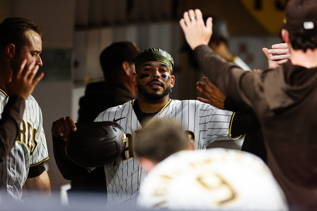 San Diego Padres' Luis Campusano is congratulate by teammates after scoring on a double hit by Miguel Andujar against the Arizona Diamondbacks in the fourth inning of a baseball game Wednesday, July 8, 2026, in San Diego. (AP Photo/Derrick Tuskan)