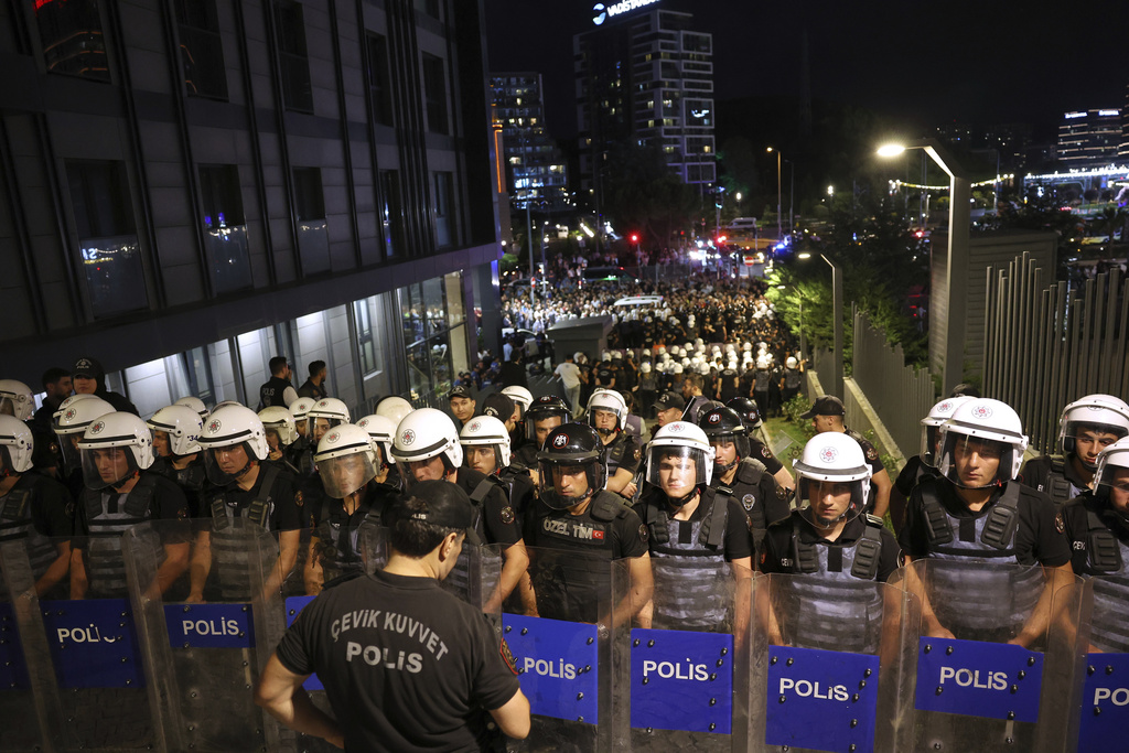 Turkish police officers stand guard as they block access to Turkey's main opposition CHP party headquarters in Istanbul, Turkey, Sunday, Sept. 7, 2025. (AP Photo/Berk Ozkan)