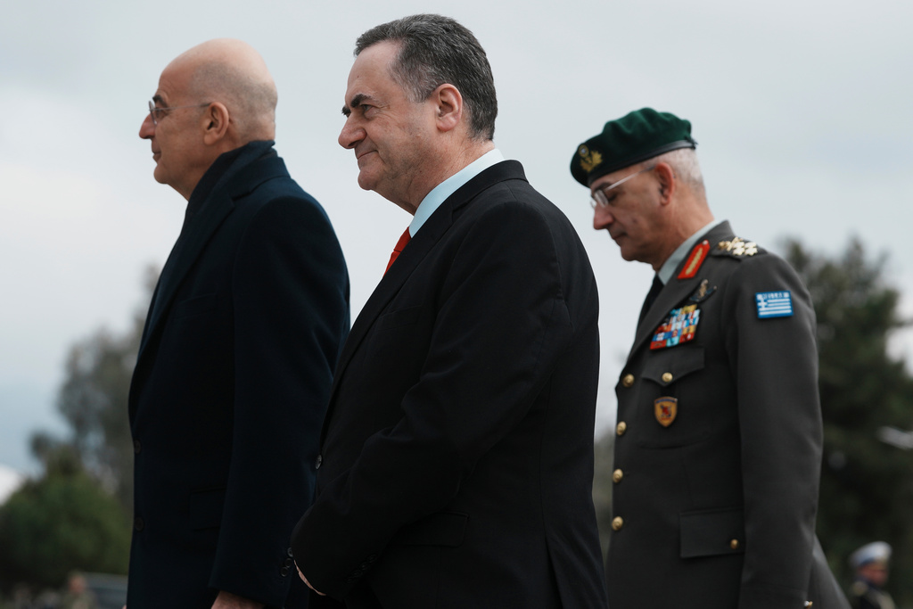 Israeli Defense Minister Israel Katz, center, reviews the honor guard with his Greek counterpart Nikos Dendias before their meeting in Athens, Greece, Tuesday, Jan. 20, 2026. (AP Photo/Thanassis Stavrakis)