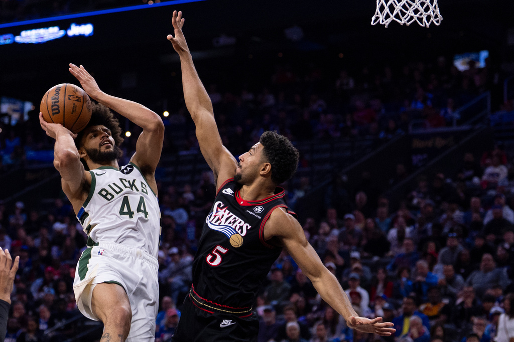 Milwaukee Bucks small forward Andre Jackson Jr., left, looks to shoot against Philadelphia 76ers shooting guard Quentin Grimes, right, during the first half of an NBA basketball game, Sunday, April 12, 2026, in Philadelphia. (AP Photo/Chris Szagola)
