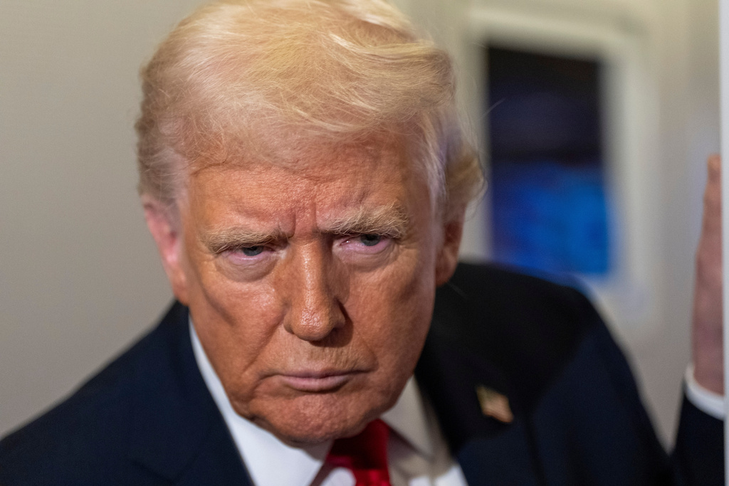President Donald Trump leans in to hear a question as he speaks with reporters while in flight on Air Force One from Joint Base Andrews to his Mar-a-Lago estate in Palm Beach, Fla., Tuesday, Nov. 25, 2025. (AP Photo/Alex Brandon)