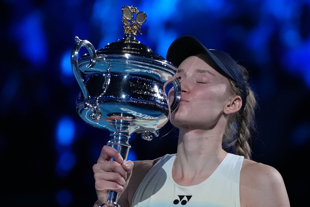 Elena Rybakina of Kazakhstan kisses the Daphne Akhurst Memorial Cup after defeating Aryna Sabalenka of Belarus to win the women's singles final at the Australian Open tennis championship in Melbourne, Australia, Saturday, Jan. 31, 2026. (AP Photo/Aaron Favila)