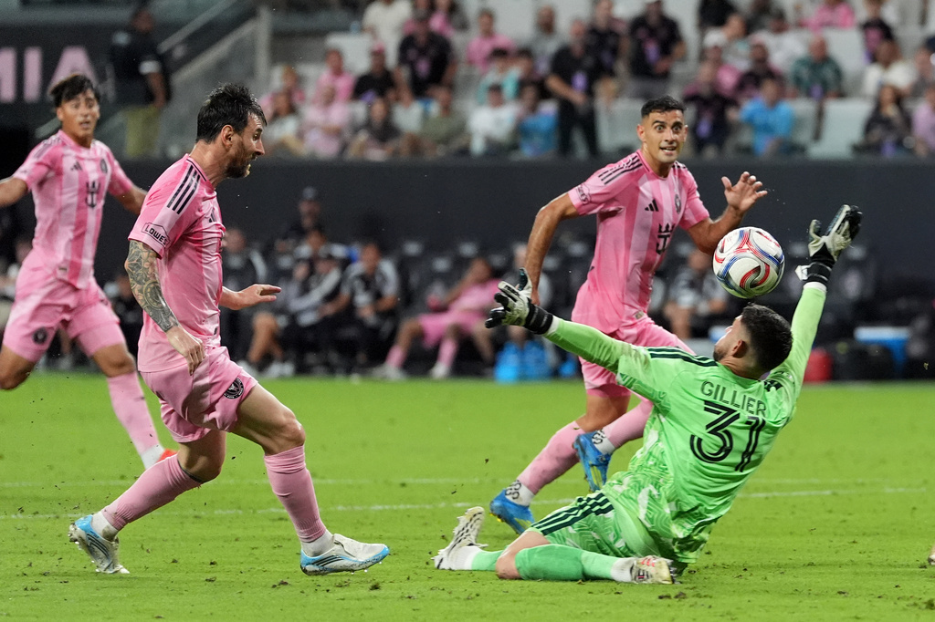 Inter Miami forward Lionel Messi, left, scores his third goal of the match, his side's fifth, past CF Montreal goalkeeper Thomas Gillier (31) during the second half of an MLS soccer match, Saturday, Aug. 29, 2026, in Miami. (AP Photo/Rebecca Blackwell)