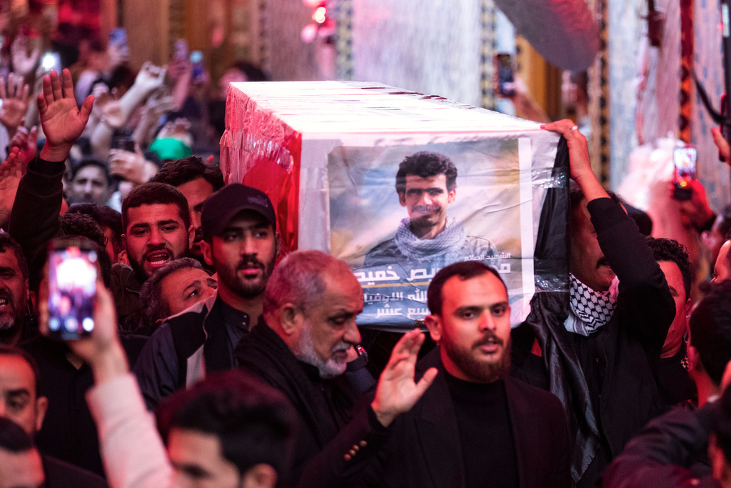 Members of the Popular Mobilization Forces attend a funeral in Najaf, Iraq, Friday, March 13, 2026 for colleagues who were killed in an airstrike in Qaim. (AP Photo/Anmar Khalil)