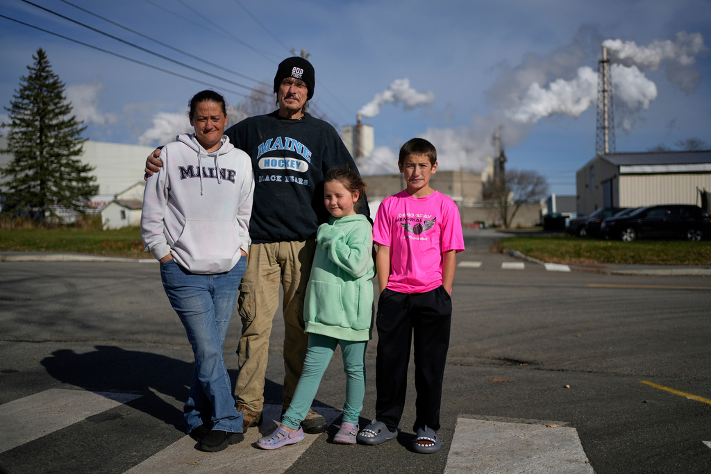 Gerard Berry with his wife Stephanie, and children Brooklynn and Aidan, pose near the Woodland Pulp mill, Friday, Nov. 7, 2025, during a walk in their neighborhood in Baileyville, Maine. (AP Photo/Robert F. Bukaty)