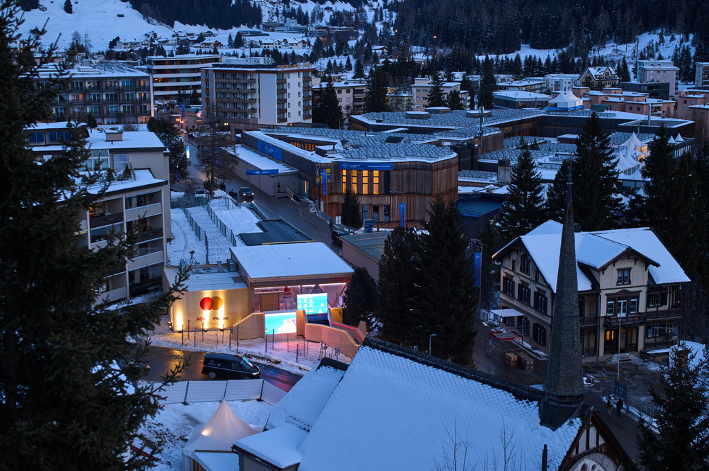 The windows of the Congress Center, center top, where the Annual Meeting of the World Economy Forum take place are illuminated in Davos, Switzerland, Saturday, Jan. 17, 2026. (AP Photo/Markus Schreiber)