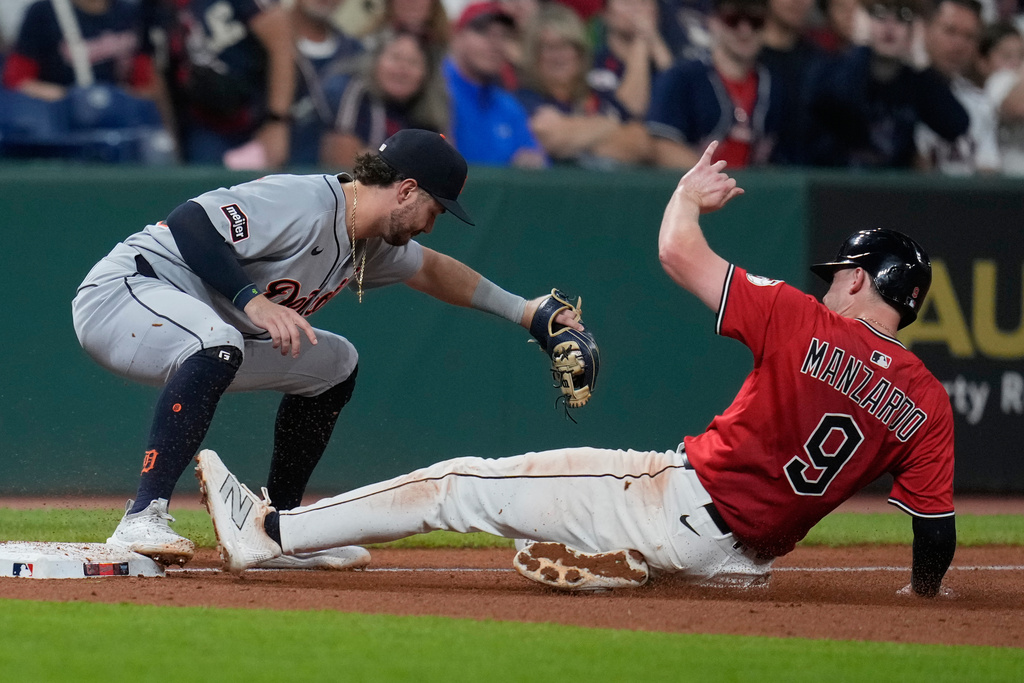 Cleveland Guardians' Kyle Manzardo (9) is forced out at third base by Detroit Tigers third baseman Zach McKinstry in the fifth inning of a baseball game in Cleveland, Tuesday, Sept. 23, 2025. (AP Photo/Sue Ogrocki)