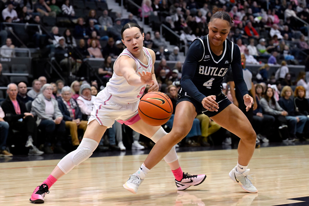 UConn guard Kayleigh Heckel (9) takes control of the ball from Butler guard Kennedy Langham (4) in the first half of an NCAA college basketball game, Saturday, Feb. 7, 2026, in Hartford, Conn. (AP Photo/Jessica Hill)