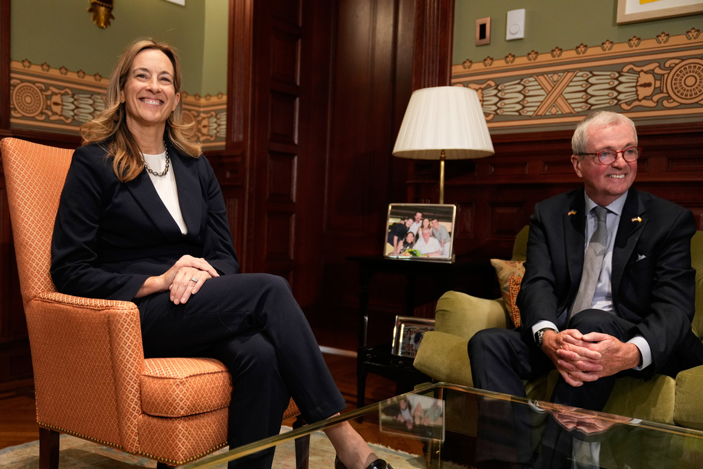 New Jersey Gov. Phil Murphy and governor-elect Mikie Sherrill talk during a photo opportunity in the governor's office in Trenton, N.J., Wednesday, Nov. 5, 2025. (AP Photo/Seth Wenig)